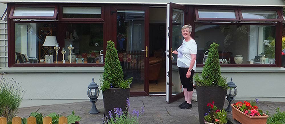 Liz holding the door open towelcoming you to Castleview B&B